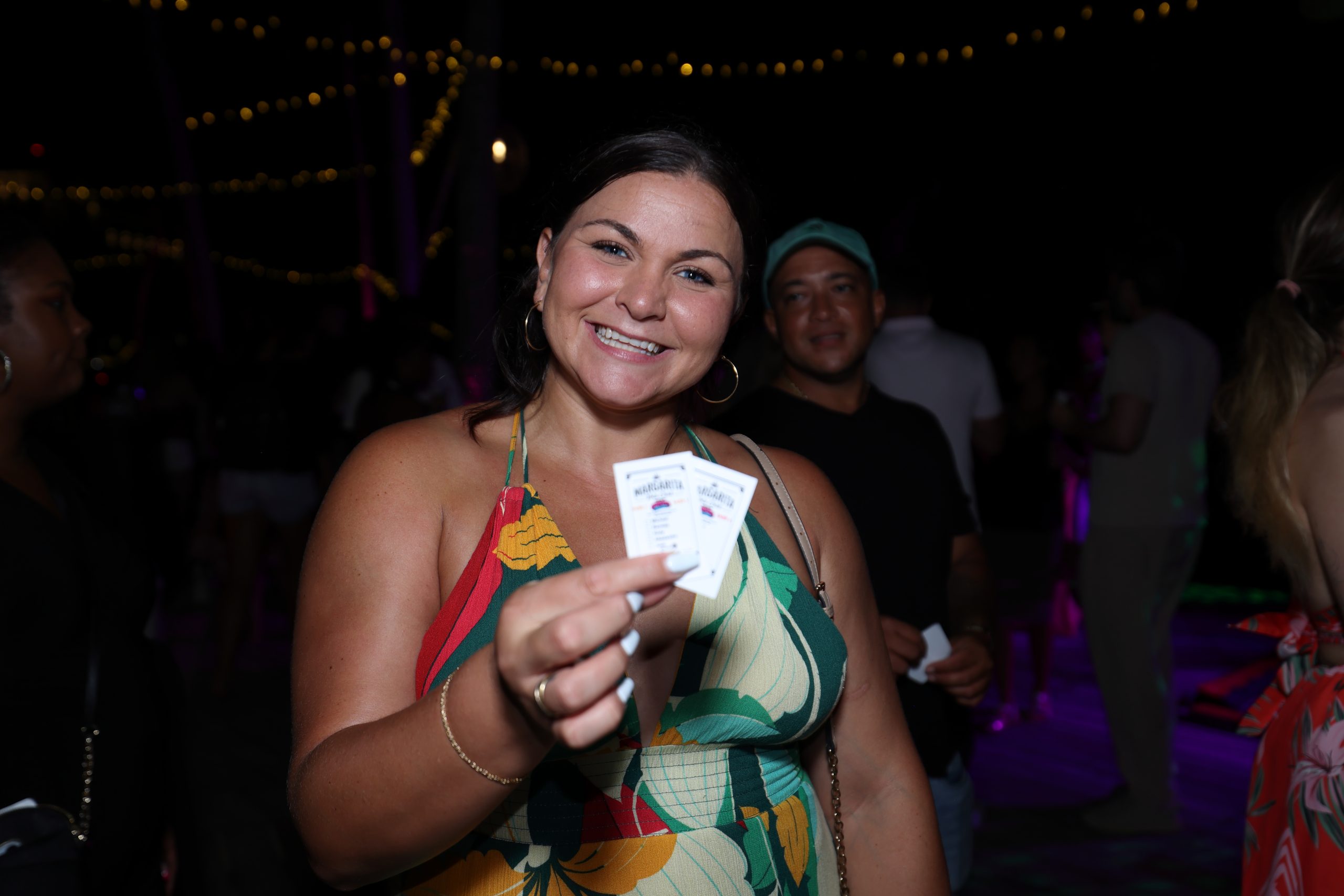 Guest holding Margarita Masters voting cards